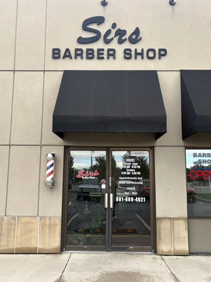 The Sirs Barber Shop storefront and front door sign at 6325 Highland Drive